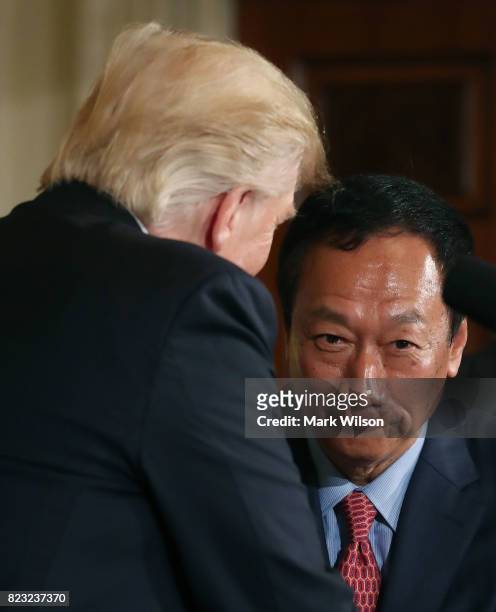Terry Gou, chairman of Apple supplier Foxconn, shakes hands with U.S. President Donald Trump at a news conference in the East Room of the White House...