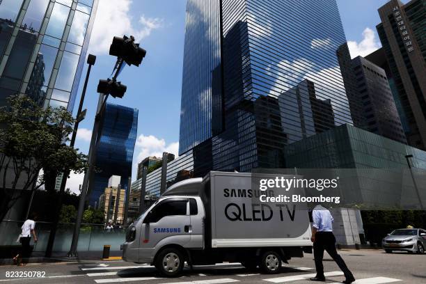 Truck featuring an advertisement for Samsung Electronics Co. QLED televisions drives past the company's Seocho office building in Seoul, South Korea,...