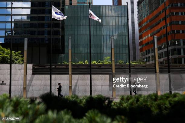 Pedestrians walk past the Samsung Electronics Co. Seocho office building in Seoul, South Korea, on Tuesday, July 25, 2017. Samsung posted earnings...