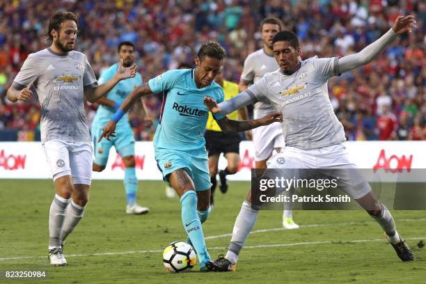 Neymar of Barcelona dribbles past Chris Smalling of Manchester United in the first half during the International Champions Cup match at FedExField on...