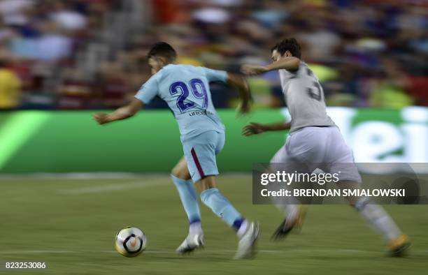 Munir El Haddadi of Barcelona and Demetri Mitchell of Manchester United fight for the ball during their International Champions Cup football match on...