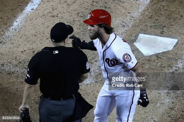 Bryce Harper of the Washington Nationals argues with home plate umpire Chris Segal after being ejected after striking out in the eighth inning...