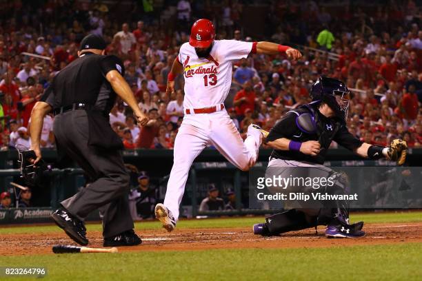 Matt Carpenter of the St. Louis Cardinals scores a run against Ryan Hanigan of the Colorado Rockies in the fourth inning at Busch Stadium on July 26,...