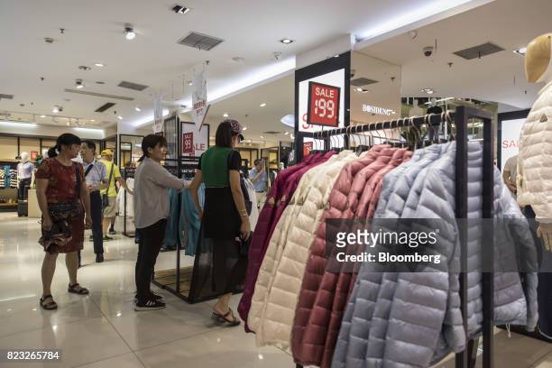 Customers shop inside the Bosideng International Holdings Ltd. Flagship clothing store in Shanghai, China, on Friday, July 14, 2017. Bosideng, a...