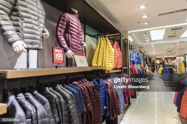 Down jackets hang on display inside the Bosideng International Holdings Ltd. Flagship clothing store in Shanghai, China, on Friday, July 14, 2017....