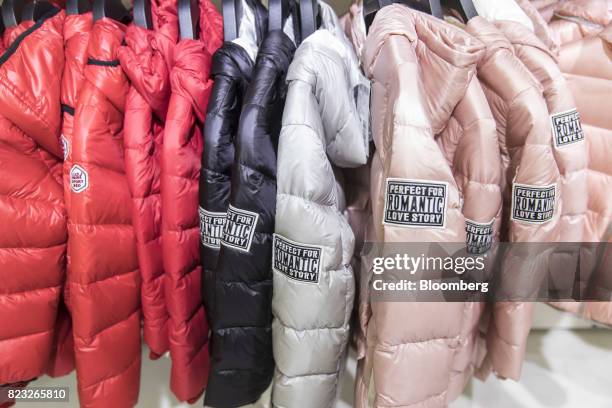 Down jackets hang on display inside the Bosideng International Holdings Ltd. Flagship clothing store in Shanghai, China, on Friday, July 14, 2017....