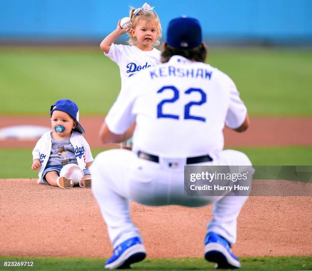 Cali Ann Kershaw throws throws out a ceremonial first pitch to her dad Clayton Kershaw of the Los Angeles Dodgers as brother Charley Kershaw sits on...