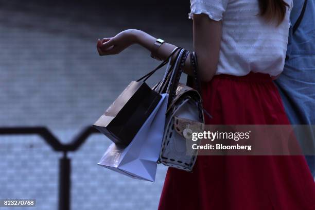 Shopper walks in the Umeda shopping area of Osaka, Japan, on Wednesday, July 26, 2017. Japan is scheduled to release June's Consumer Price Index...