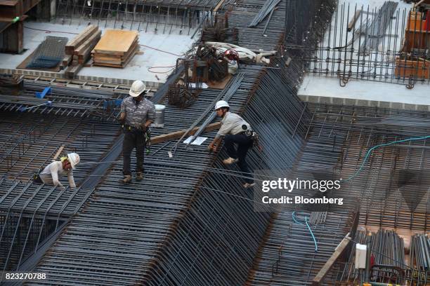 Workers labor at an underground railway facilities construction site in Osaka, Japan, on Wednesday, July 26, 2017. Japan is scheduled to release...