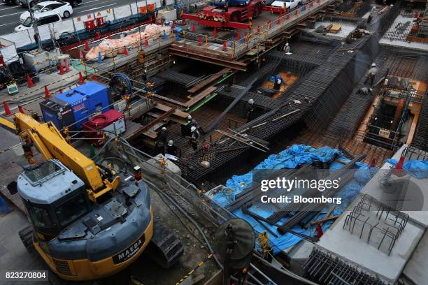 Workers labor at an underground railway facilities construction site in Osaka, Japan, on Wednesday, July 26, 2017. Japan is scheduled to release...