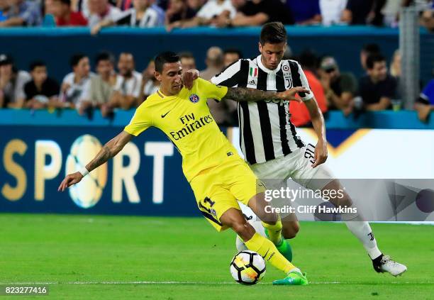 Angel Di Maria of Paris Saint-Germain controls the ball against Rodrigo Bentacur of Juventus in the first half during their International Champions...
