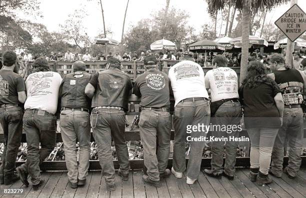 Bikers look down on the action behind the Crazy Horse Saloon March 6, 2000 during Daytona Beach Bike Week in Daytona Beach, Florida. The annual...