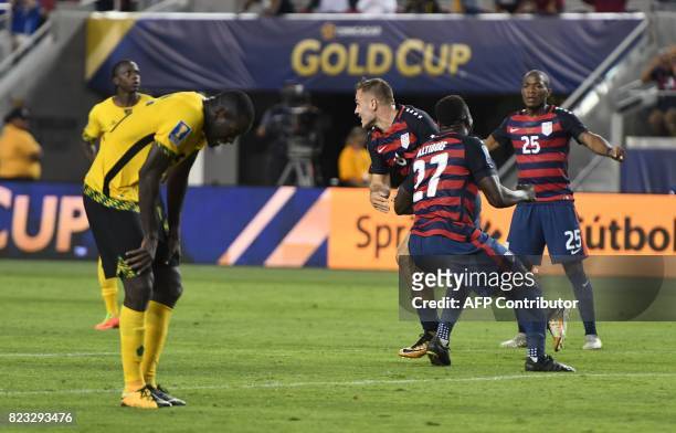 S Jordan Morris celebrates with teammate Jozy Altidore and Darlington Nagbe after scoring a goal against Jamaica during the final football game of...