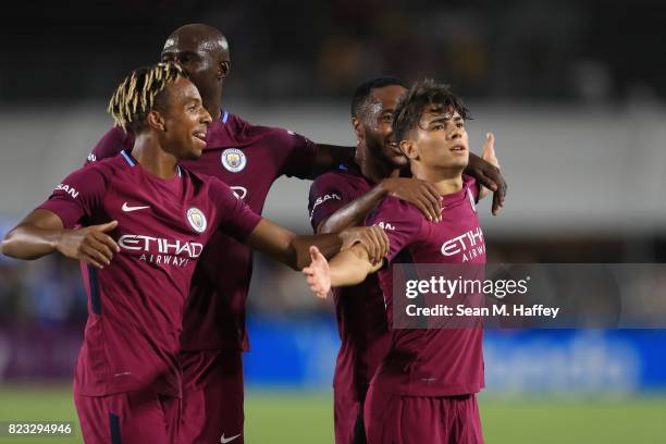 Demeaco Duhaney, Eliaquim Mangala and Raheem Sterling congratulate Brahim Diaz of Manchester City after he scored a goal during the second half of...