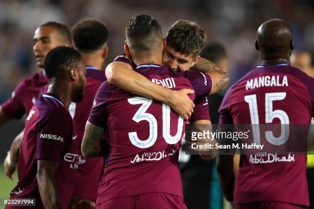 John Stones congratulates Nicolas Otamendi of Manchester City after scoring a goal during the second half of the International Champions Cup soccer...