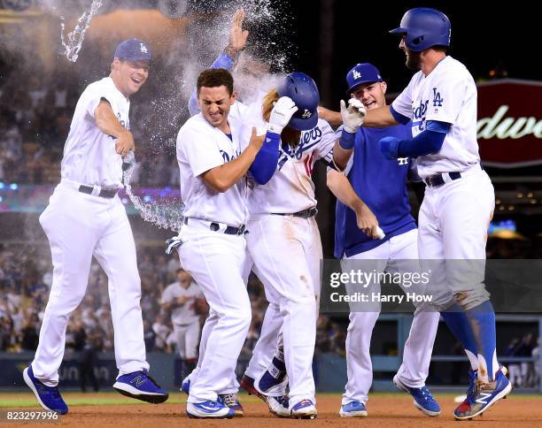 Justin Turner of the Los Angeles Dodger celebrates his game winning single to score a run with Rich Hill, Austin Barnes, Alex Wood and Chris Taylor...