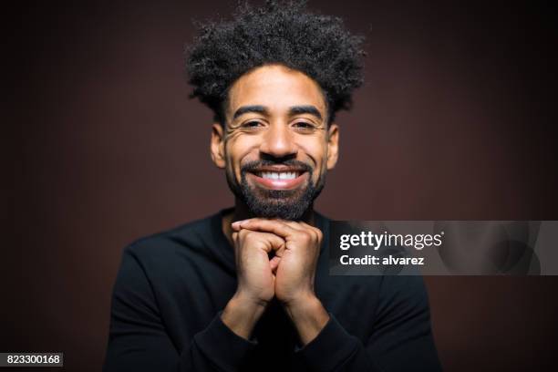 portret van vrolijke man met gevouwen handen - brown moustache cutout stockfoto's en -beelden