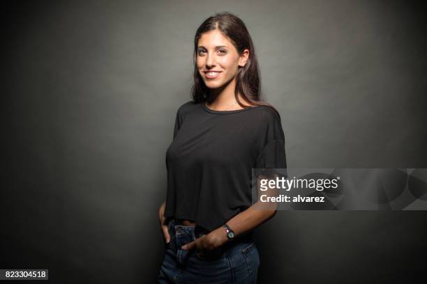 gelukkig jonge vrouw met handen in de zakken - formeel portret stockfoto's en -beelden