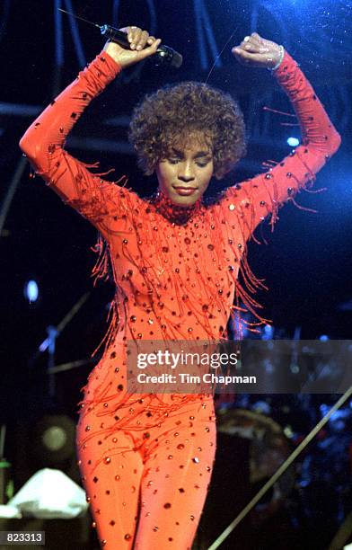 Whitney Houston sings in concert in Miami June 11, 1991.