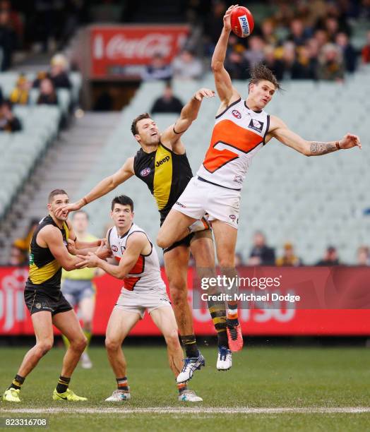 Rory Lobb of the Giants taps the ball from Toby Nankervis of the Tigers during the round 18 AFL match between the Richmond Tigers and the Greater...