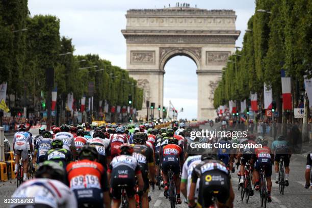 The peloton rides down the Champs-Elysees towards the Arc de Triomphe during stage 21 of the 2017 Le Tour de France, a 103km stage from Montgreon to...