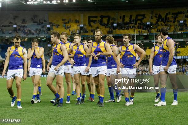 Dejected West Coast Eagles players walk from the ground after the round 18 AFL match between the Collingwood Magpies and the West Coast Eagles at...
