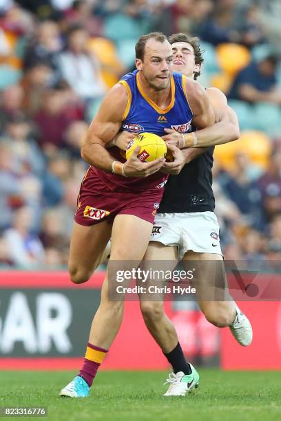 Josh Walker of the Lions is tackled during the round 18 AFL match between the Brisbane Lions and the Carlton Blues at The Gabba on July 23, 2017 in...