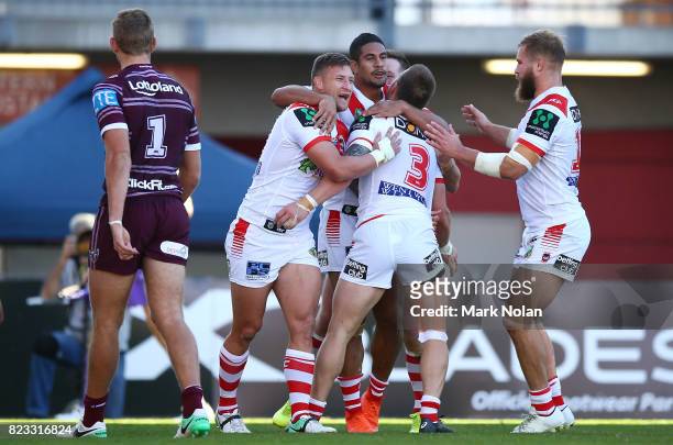 Euan Aitken of the Dragons celebrates with team mates after scoring a try during the round 20 NRL match between the St George Illawarra Dragons and...