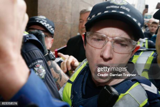 Cardinal George Pell leaves the Melbourne Magistrates Court with a heavy police guard in Melbourne on July 26, 2017 in Melbourne, Australia. Cardinal...