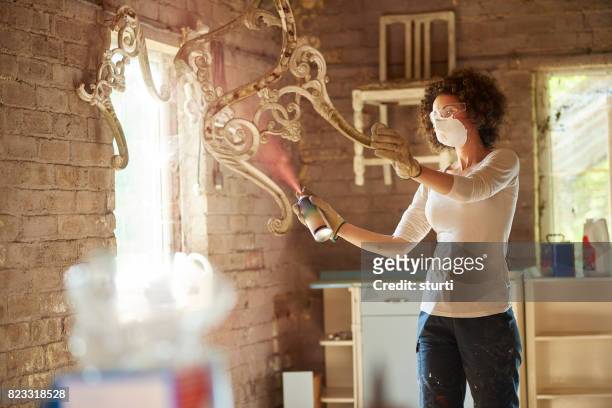 busy in her workshop - spray paint stock pictures, royalty-free photos & images