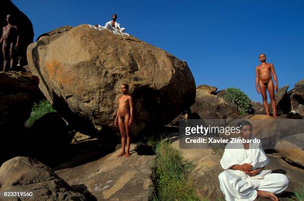 Called Muni Digambara, said to be clothed by space, sky, or light, naked Jain monks meditating in nature among rocks, with two novices clothed in...