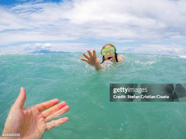reaching for a helping hand - drowning stock pictures, royalty-free photos & images