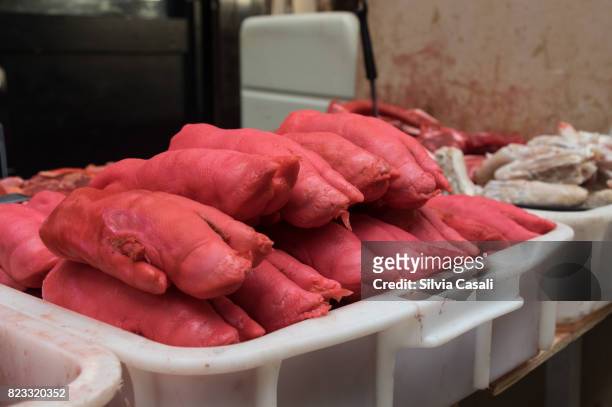 red pork legs on a basket displayed on a street market - silvia casali stock-fotos und bilder