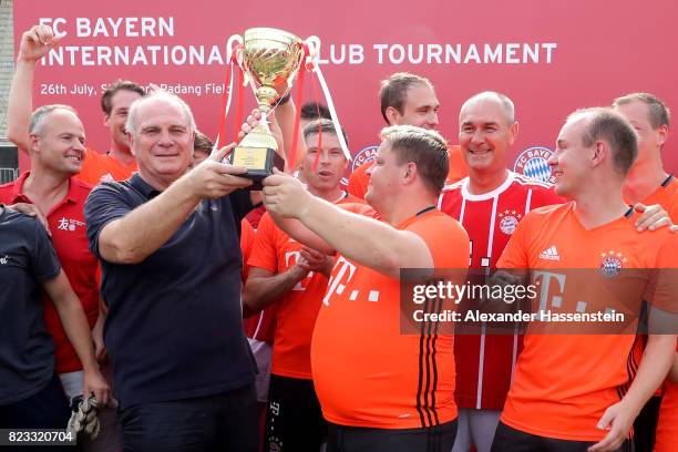 Uli Hoeness, President of FC Bayern Muenchen hands-over the winners trophy to the winning team after the FC Bayern International Fanclub Tournament...