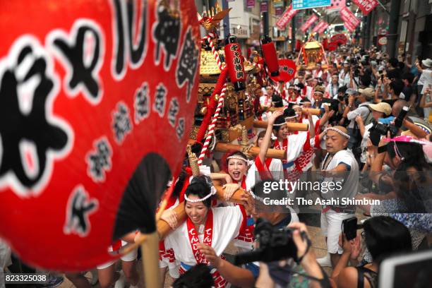 The popular "Gal Mikoshi" is paraded at Tenjinbashisuji shopping street on July 23, 2017 in Osaka, Japan. The troop of 80 women, from 15 to 30 years...