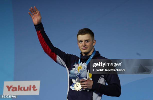 Adam Peaty of Great Britain poses with his gold medal from the final of Men's 100m Breaststroke on day eleven of the FINA World Championships at the...