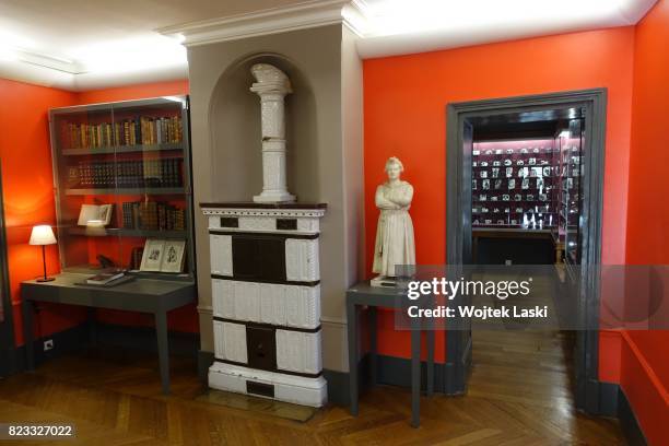 Maison de Balzac - a house museum in the former residence of French novelist Honore de Balzac . Pictured: a collection of books, masonry heater and a...