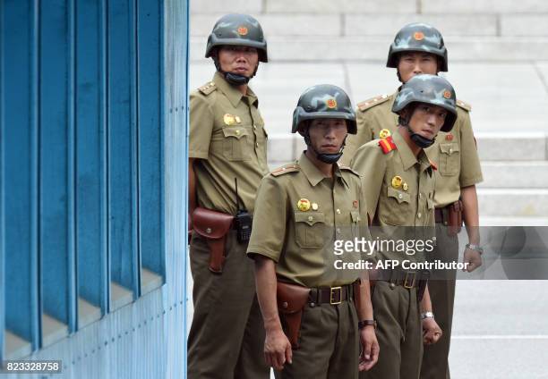 North Korean soldiers watch the South side as the United Nations Command officials visit after a commemorative ceremony for the 64th anniversary of...