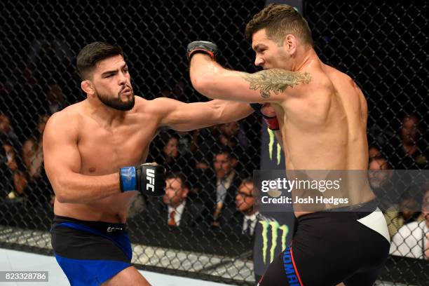 Kelvin Gastelum punches Chris Weidman in their middleweight bout during the UFC Fight Night event inside the Nassau Veterans Memorial Coliseum on...