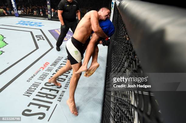 Chris Weidman takes down Kelvin Gastelum in their middleweight bout during the UFC Fight Night event inside the Nassau Veterans Memorial Coliseum on...