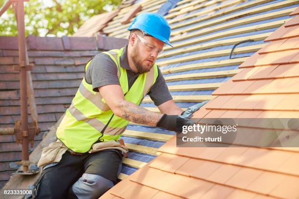 roofer on the roof - roofer stock pictures, royalty-free photos & images