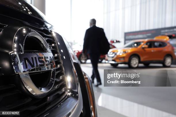 Nissan Motor Co. X-Trail vehicle, left, is displayed at the company's showroom in Yokohama, Japan, on Thursday, July 27, 2017. Nissan is counting on...