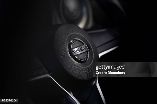 The Nissan Motor Co. Badge is displayed on the steering wheel of a Note e-Power hybrid vehicle at the company's showroom in Yokohama, Japan, on...