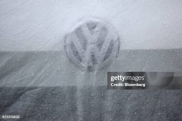 Protective cover sits on a new Volkswagen Golf automobile outside a Volkswagen AG showroom in Berlin, Germany, on Wednesday, July 26, 2017....