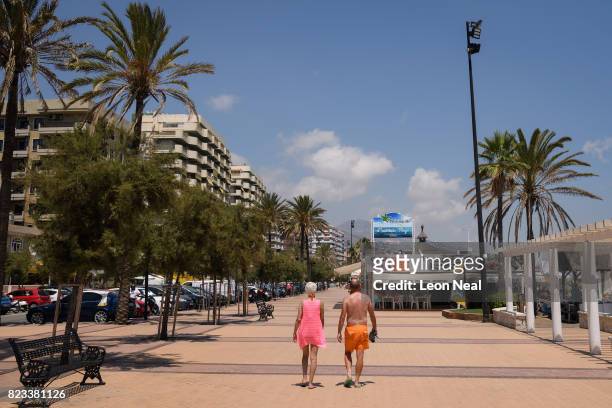 Couple walk along the beachside promenade on July 25, 2017 in Fuengirola, Spain. With Brexit discussions yet to provide answers to a number of...