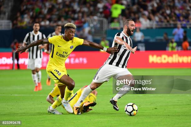 Gonzalo Gerardo Higuain of Juventus brings the ball away from Marco Verratti of PSG and Kimpembe Presnel of PSG during the International Champions...