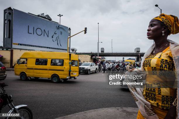 Pedestrian passes a large electronic advertising screen on a busy road in Lagos, Nigeria, on Wednesday, July 26, 2017. Nigeria's economy, which in...