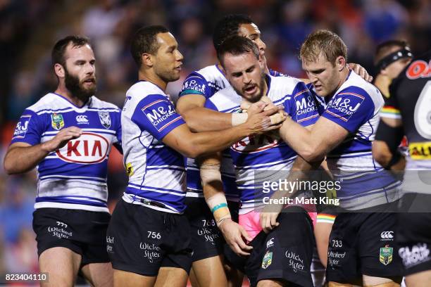 Josh Reynolds of the Bulldogs celebrates with team mates after scoring a try during the round 21 NRL match between the Penrith Panthers and the...