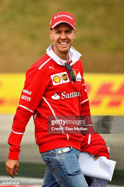 Sebastian Vettel of Germany and Ferrari walks the circuit with his engineers during previews ahead of the Formula One Grand Prix of Hungary at...