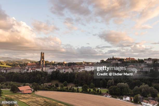 sunset over fribourg medieval town in switzerland - freiburg skyline stock pictures, royalty-free photos & images